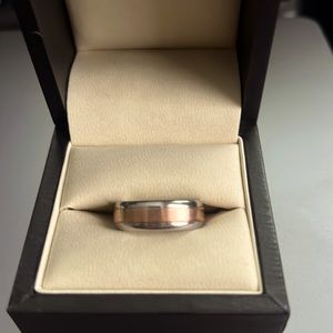 Fashionable stainless steel with rose gold band. Size 8.